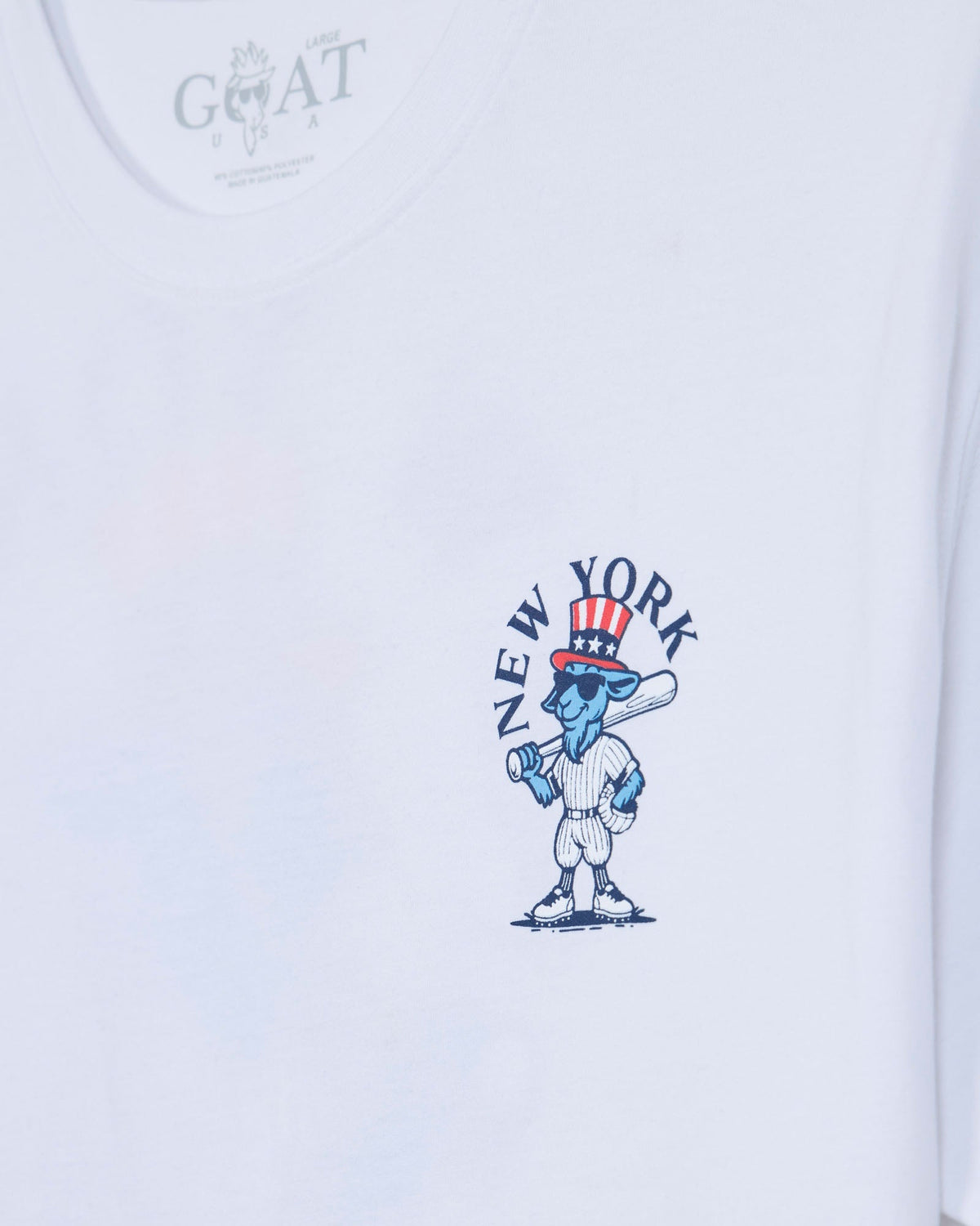White short-sleeve t-shirt featuring a blue cartoon character wearing a red, white, and blue Uncle Sam top hat, with the text 'NEW YORK' arched above it. The inner neck label shows the brand 'GOAT'.#color_white