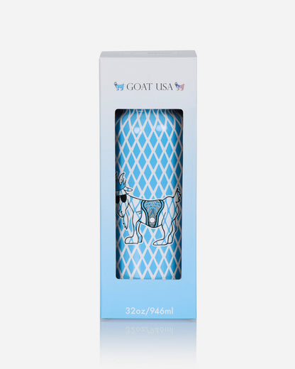 A tall, narrow white and light blue retail box with a clear window showing a cylindrical container printed with a blue diamond pattern and a goat illustration. The box is branded GOAT USA at the top and reads 32oz/946ml at the bottom, on a light gray background.