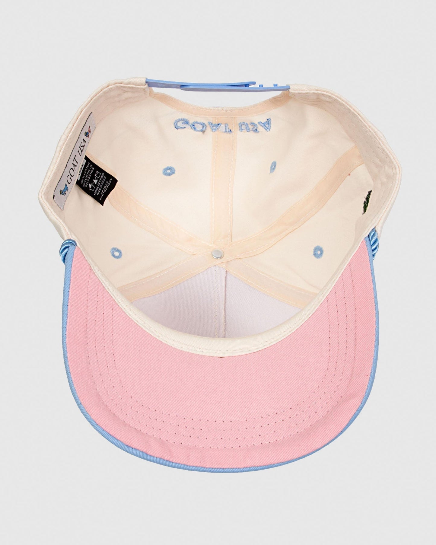 Underside of stone colored hat showcasing pink brim