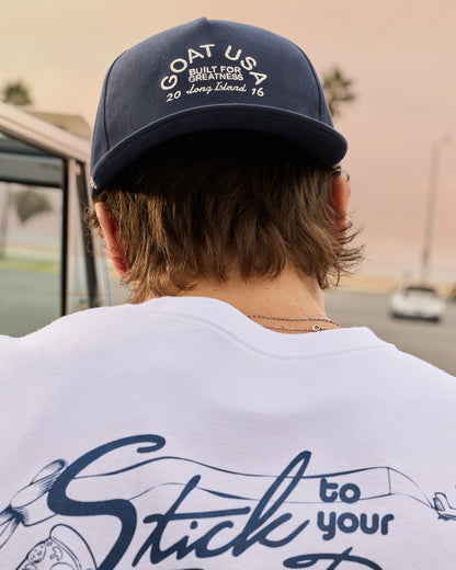 Man with backwards hat on looking downwards