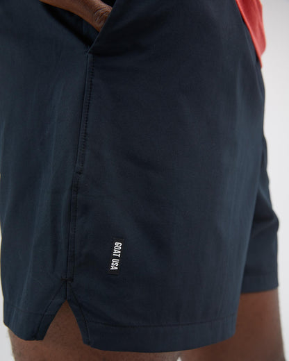 Black shorts with a brand logo on a white background#color_black