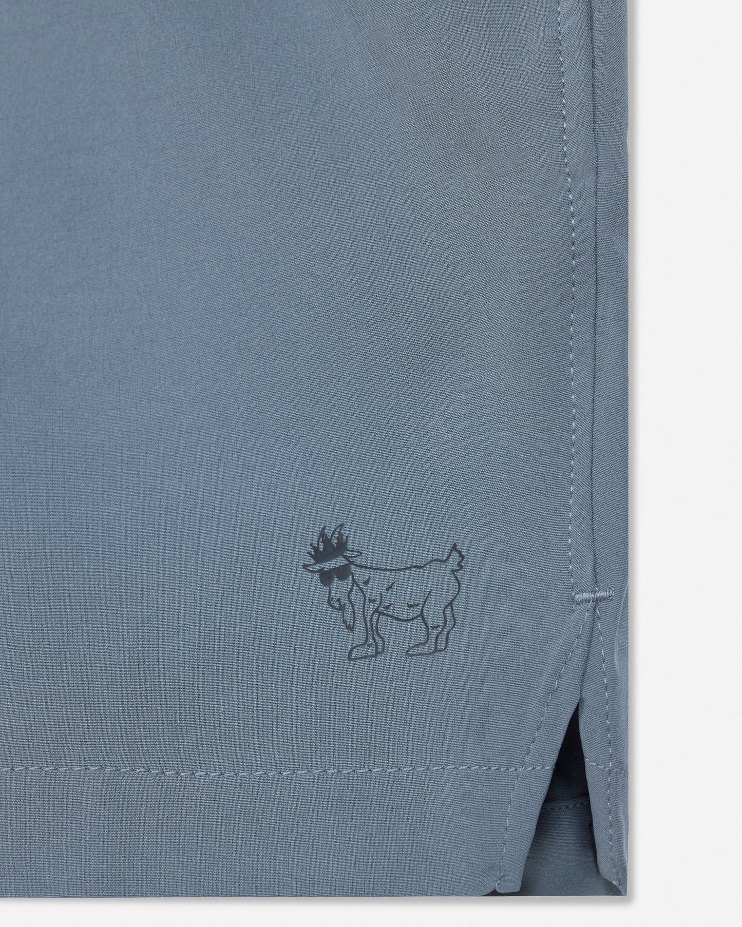 Gray fabric with a small embroidered design of a goat wearing in a crown.#color_storm-gray