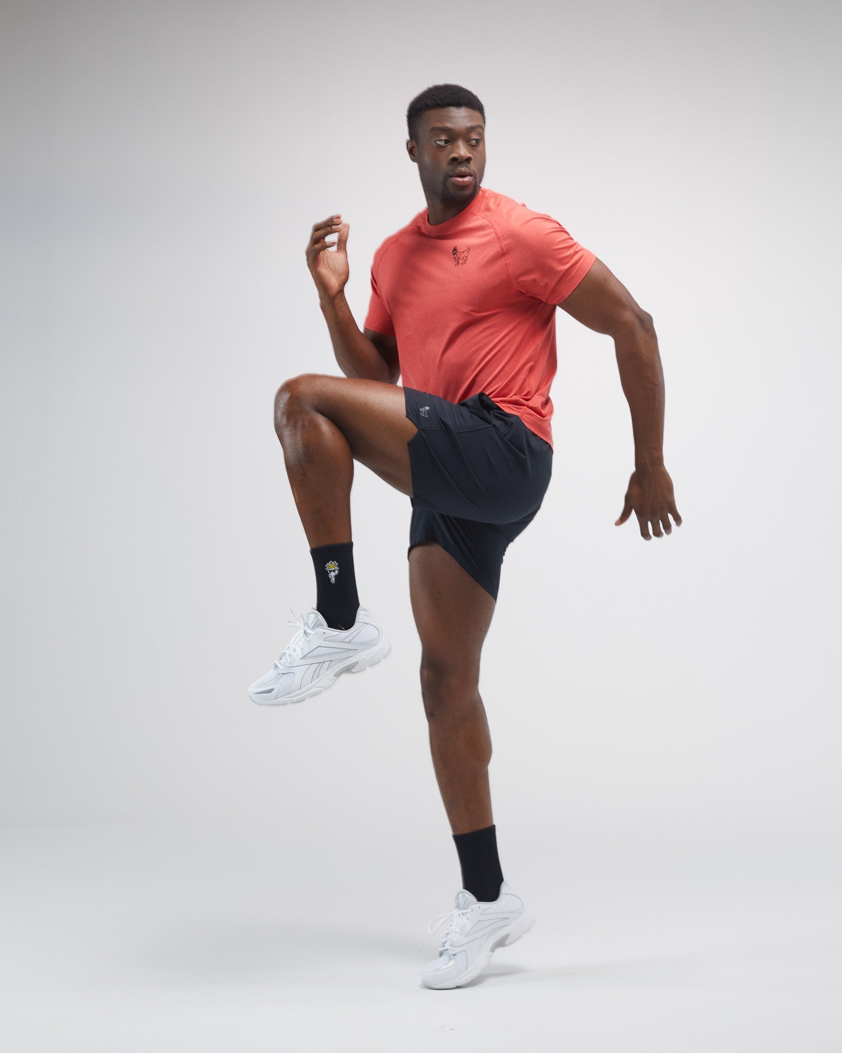 Man in athletic wear posing on a plain background#color_black