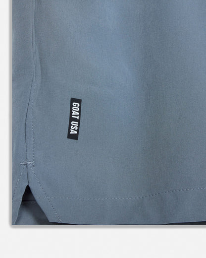 Close-up of a gray garment with a 'GOAT USA' label on a light gray background#color_storm-gray