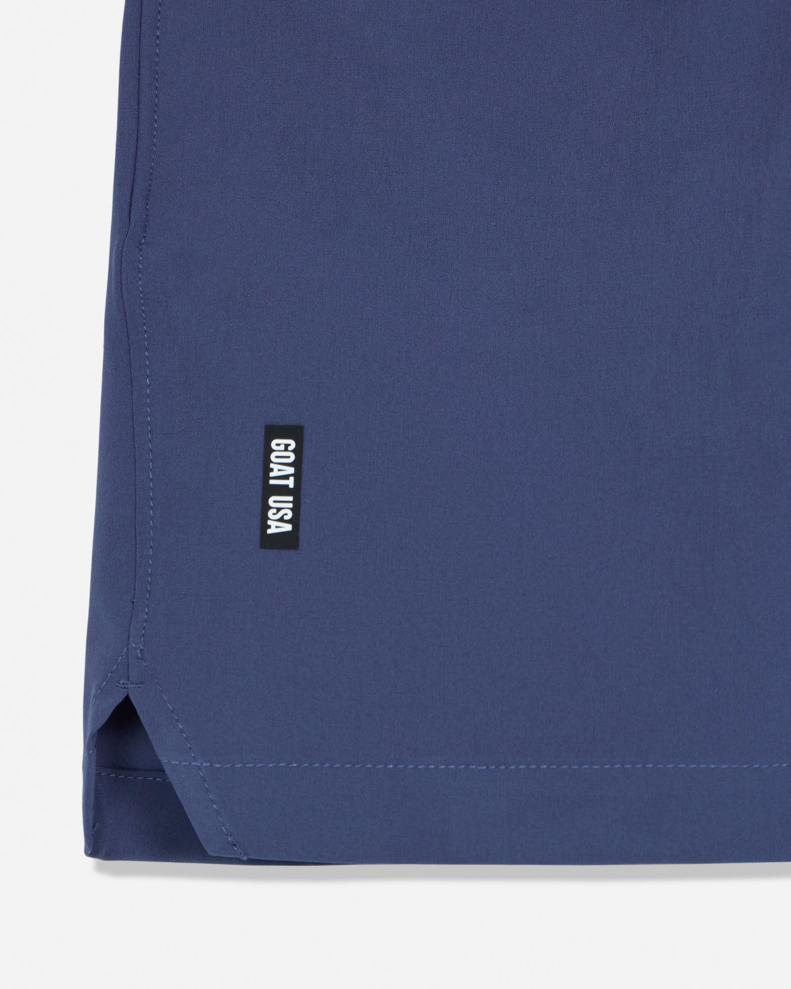 Navy blue fabric with a small black label on a white background#color_navy