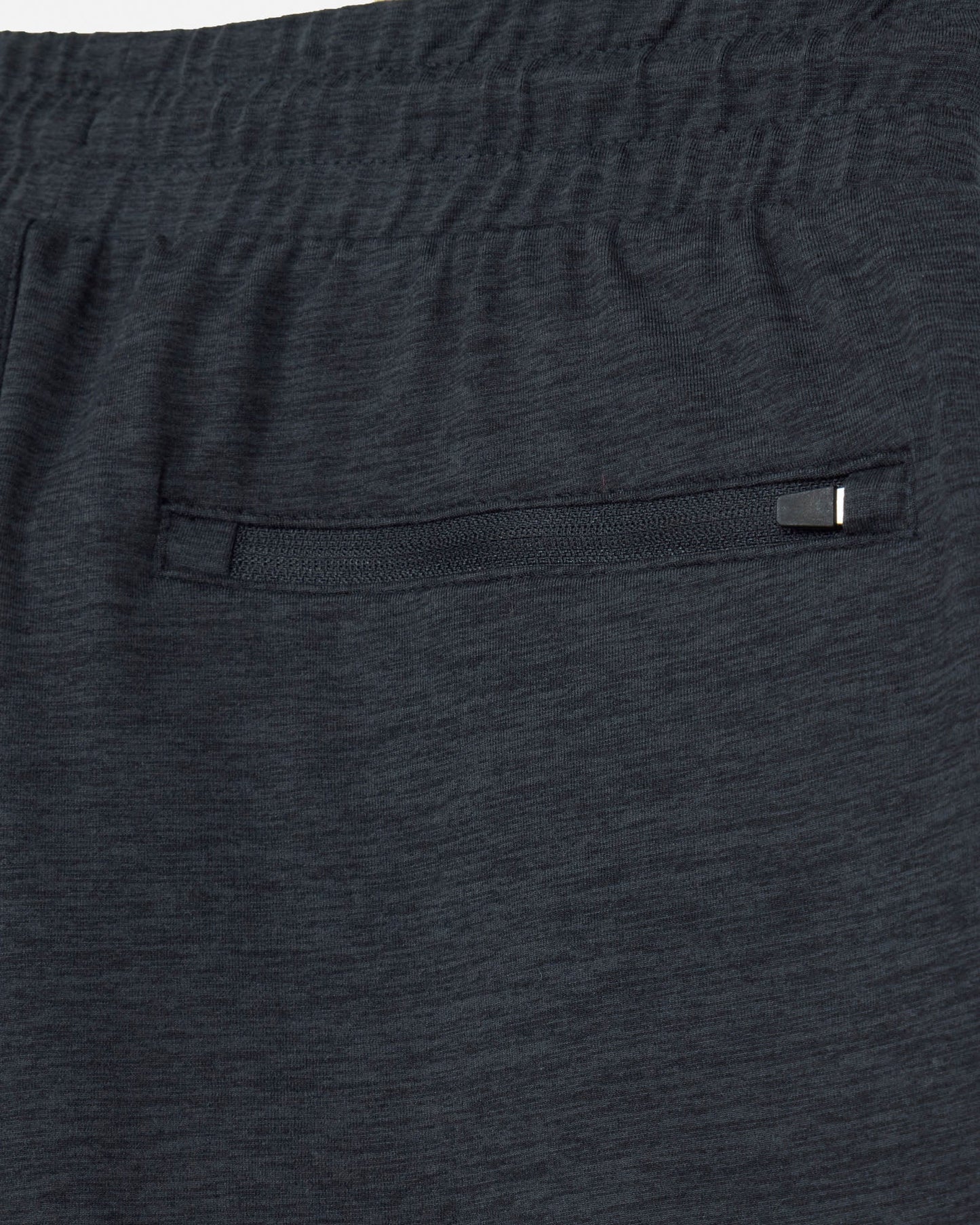 Close-up of dark gray shorts with a pocket and button.#color_space-dye-black