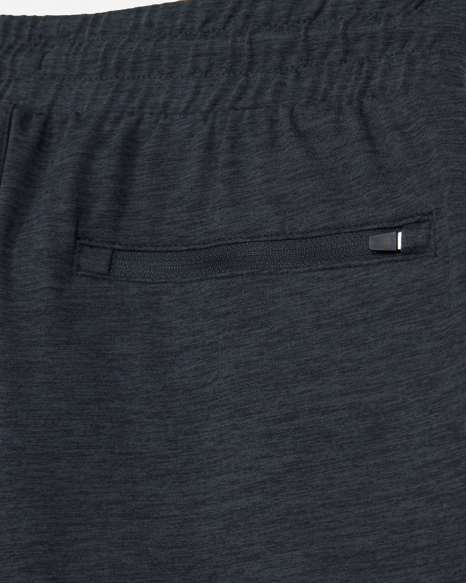 Close-up of dark gray shorts with a pocket and button.#color_space-dye-black
