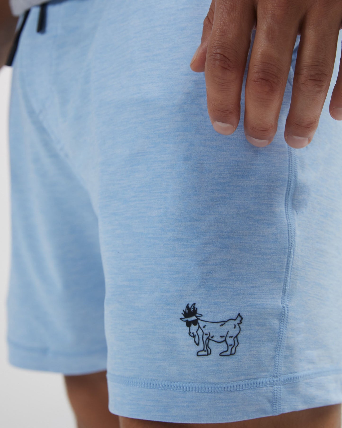 Light blue shorts with a small black design on a white background#color_carolina-blue