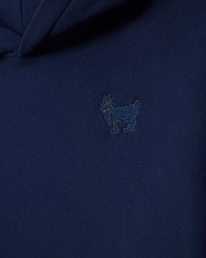 Navy blue polo shirt with a small embroidered logo on the chest.#color_navy-blazer