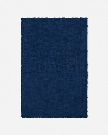 A dark navy blue rectangular blanket with a textured, embossed checkerboard pattern and fringed edges, shown flat against a light gray background.