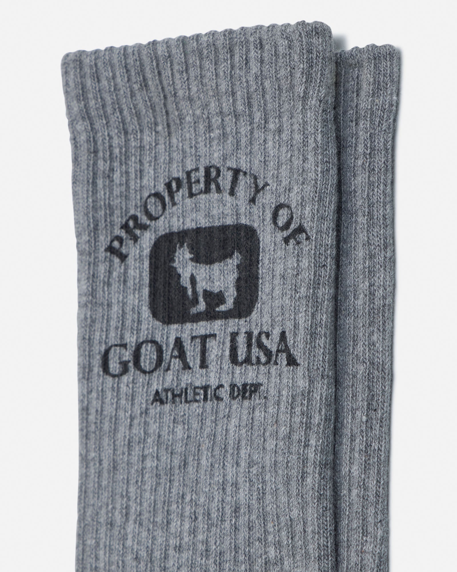 Gray socks with 'Property of Goat USA' logo on a white background
