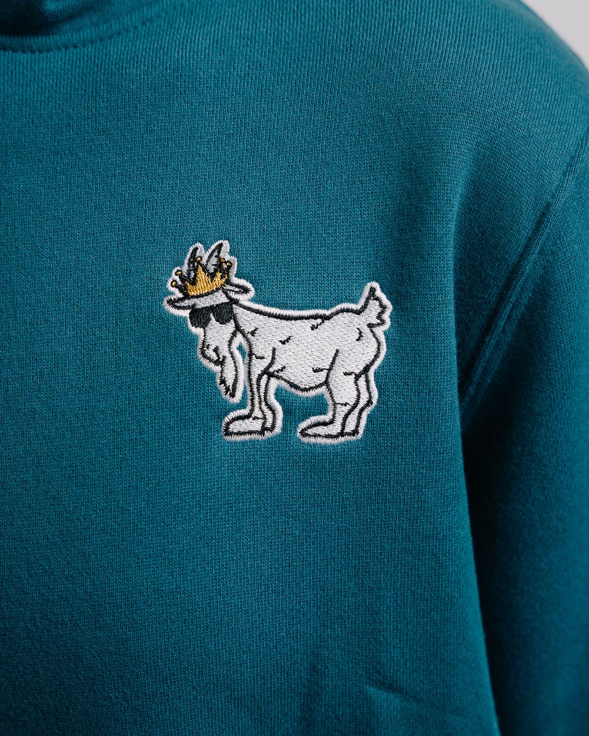 Close-up of logo on emerald WG Hooded Sweatshirt#color_emerald