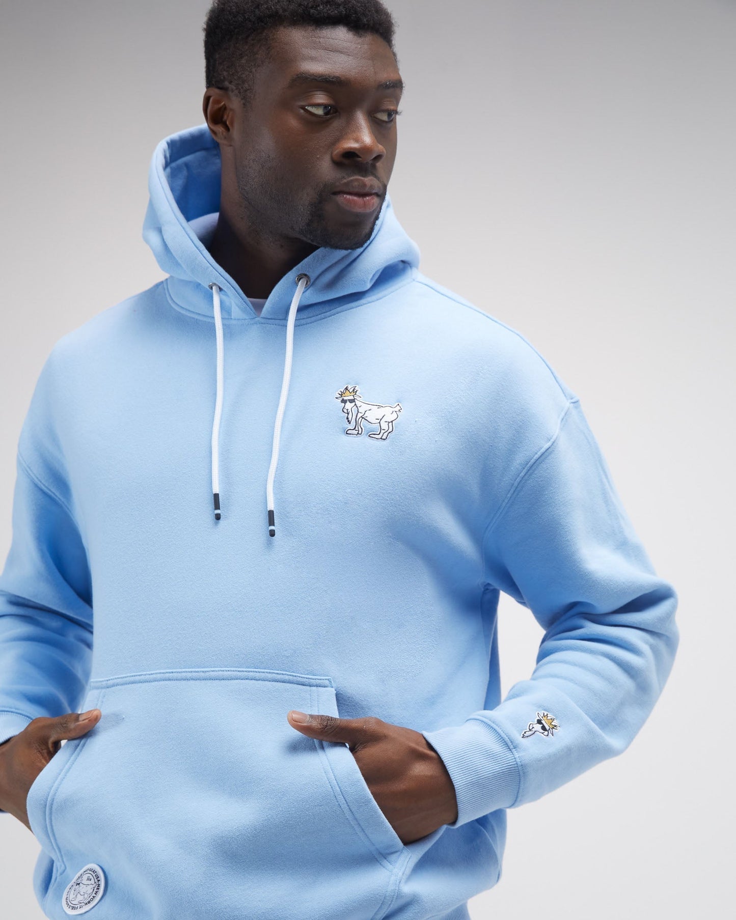Person wearing carolina blue hooded sweatshirt#color_carolina-blue