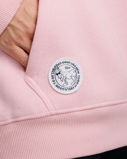Close-up of patch on pink WG Hooded Sweatshirt#color_pink
