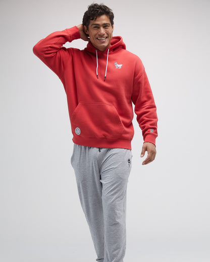 Model wearing red sweatshirt on a ight-gray background#color_poinsettia