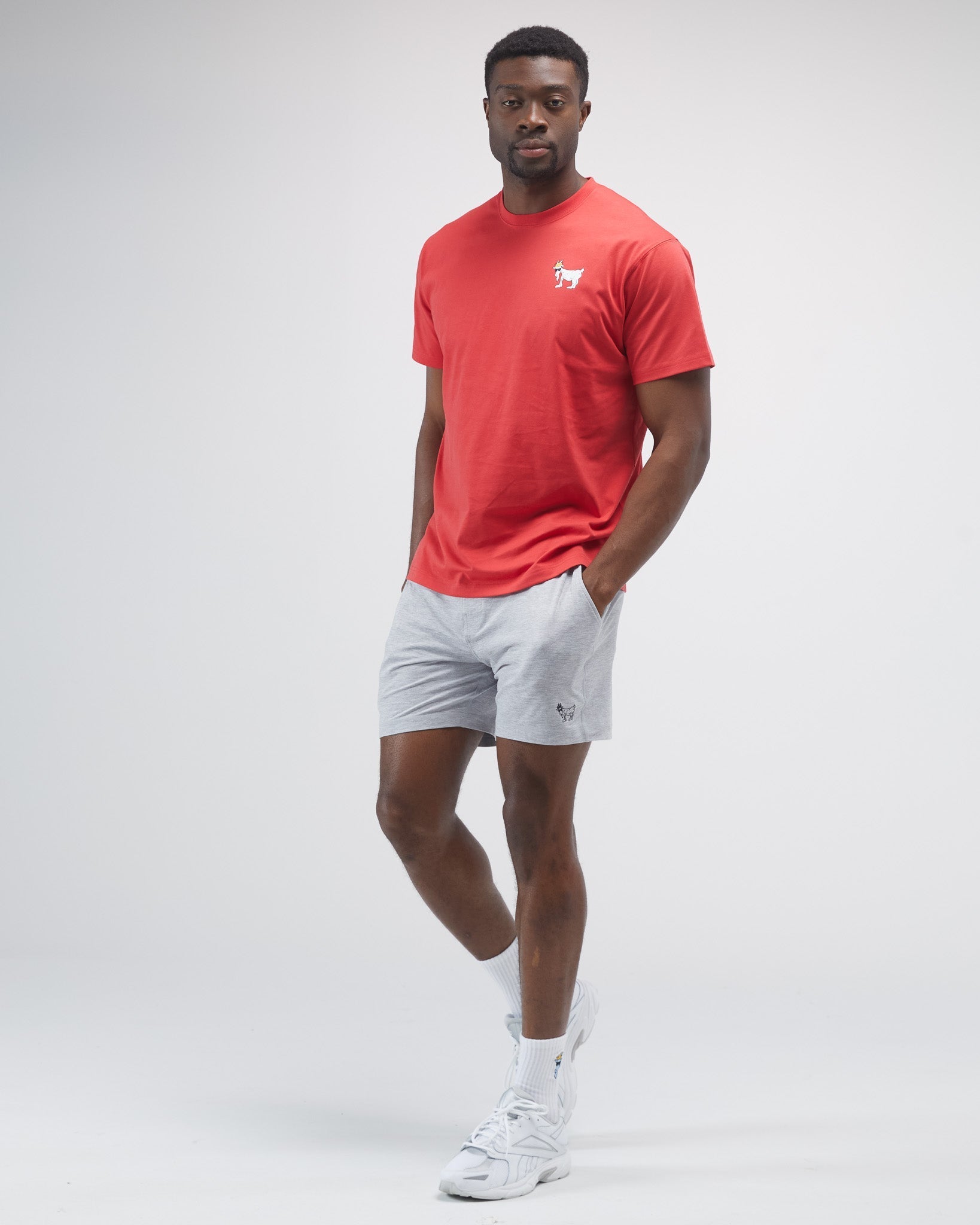 Model wearing a red t-shirt against a light-gray background#color_poinsettia
