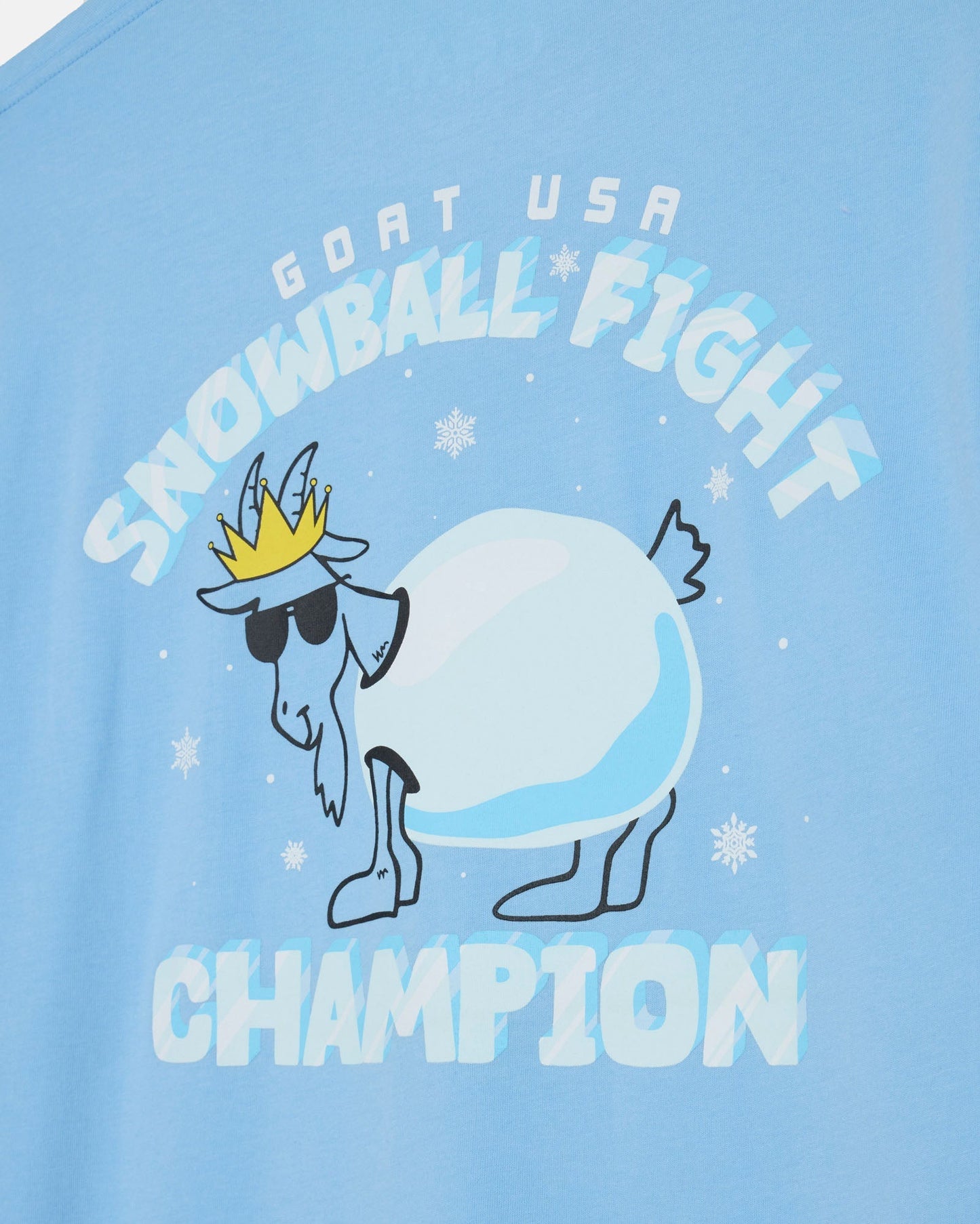 Light blue t-shirt with a graphic of a goat snowball and text 'GOAT USA SNOWBALL FIGHT CHAMPION' on a light blue background.