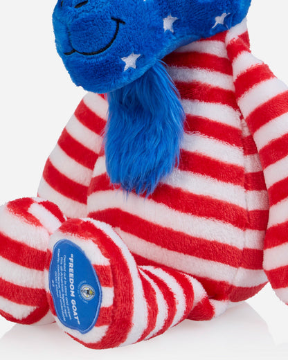 Plush toy with red, white, and blue stripes and a blue patch on a white background