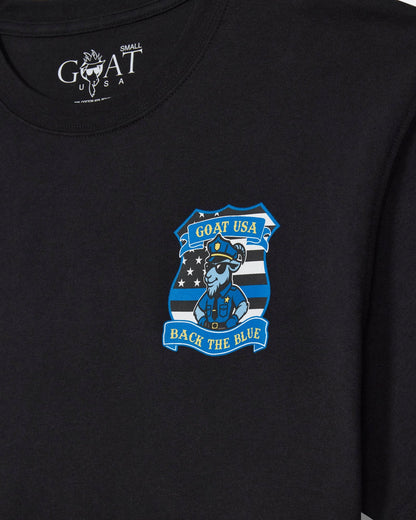 Close-up of a black short-sleeve t-shirt with a blue and white 'GOAT USA Back the Blue' police officer graphic on the left chest.