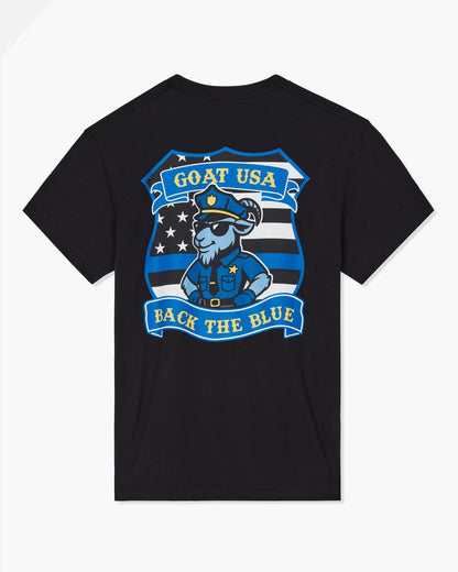 A black short-sleeve t-shirt shown from the back, featuring a large graphic print of a cartoon goat in a police uniform with the text 'GOAT USA BACK THE BLUE' on a light gray background.