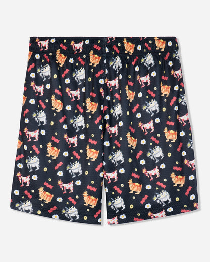 A pair of black shorts featuring an all-over whimsical pattern of cartoon goats, red roses, and small white flowers, displayed flat against a light gray background.