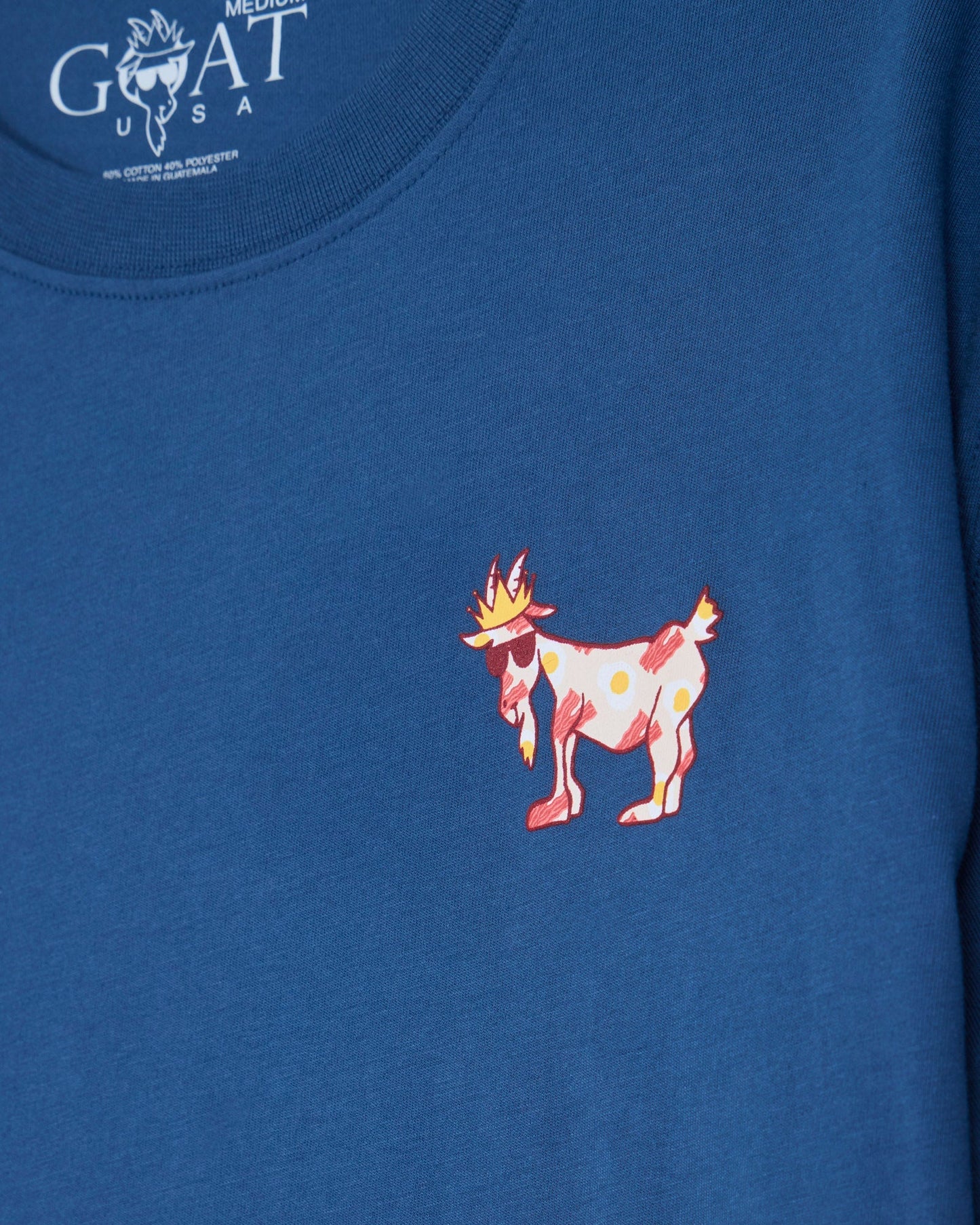 Bacon and eggs goat left-chest graphic on a blue t-shirt