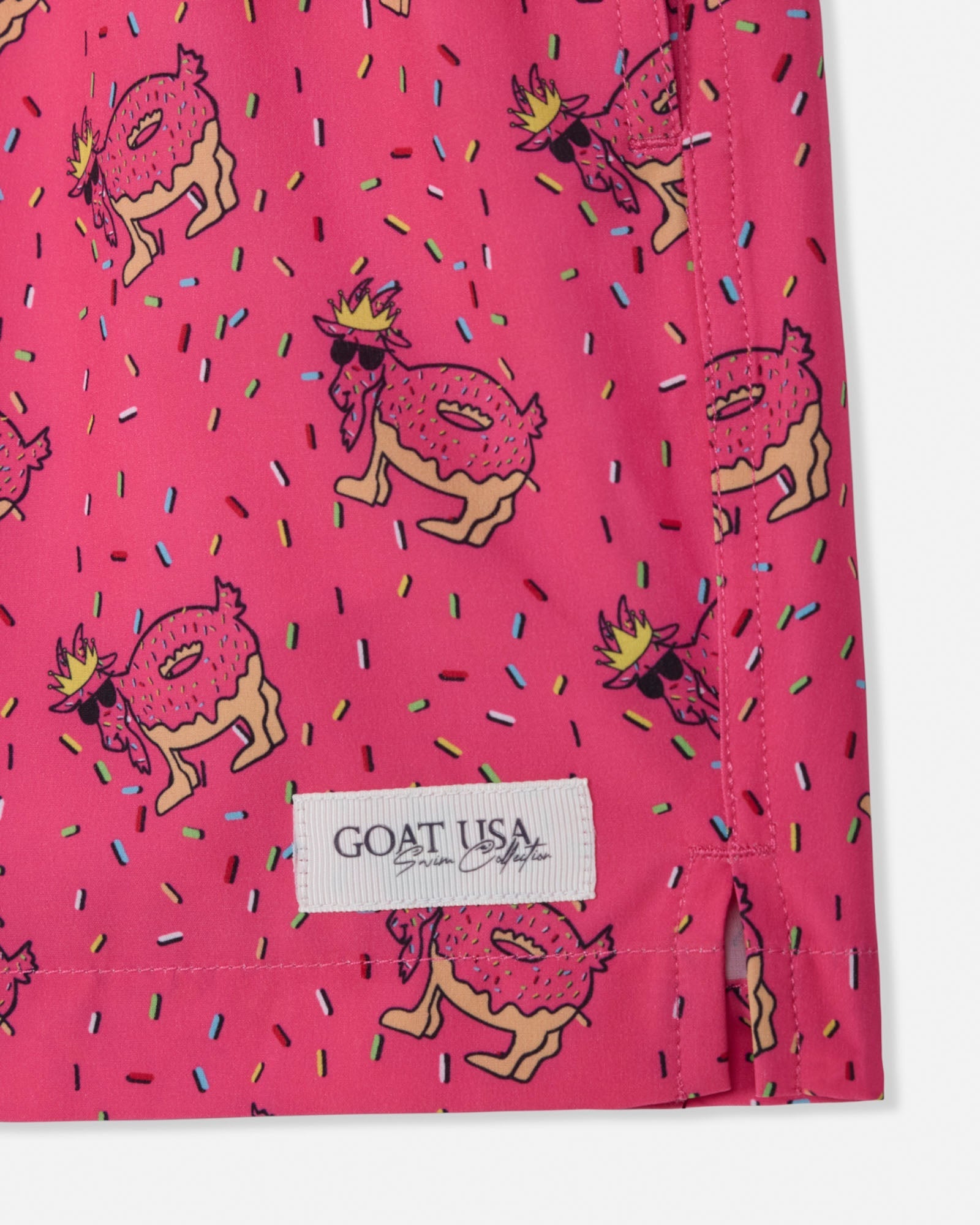 Pink shorts with cartoon donut design and 'GOAT USA' label.