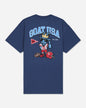 A navy blue short-sleeve t-shirt with a large graphic on the back. The graphic features the text 'GOAT USA' in light blue, a cartoon goat mascot wearing a gold crown and sunglasses, a red football helmet, and a red and white pennant.