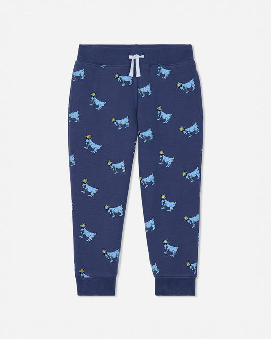 A pair of navy blue jogger pants featuring an all-over print of cartoon cows in light blue and yellow, with a white drawstring at the elastic waistband.#color_navy