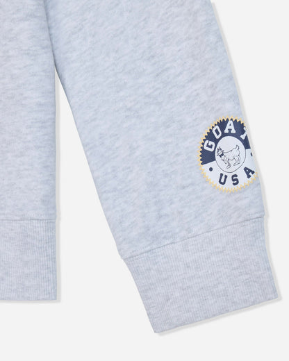 Sleeve of gray crewneck with patch