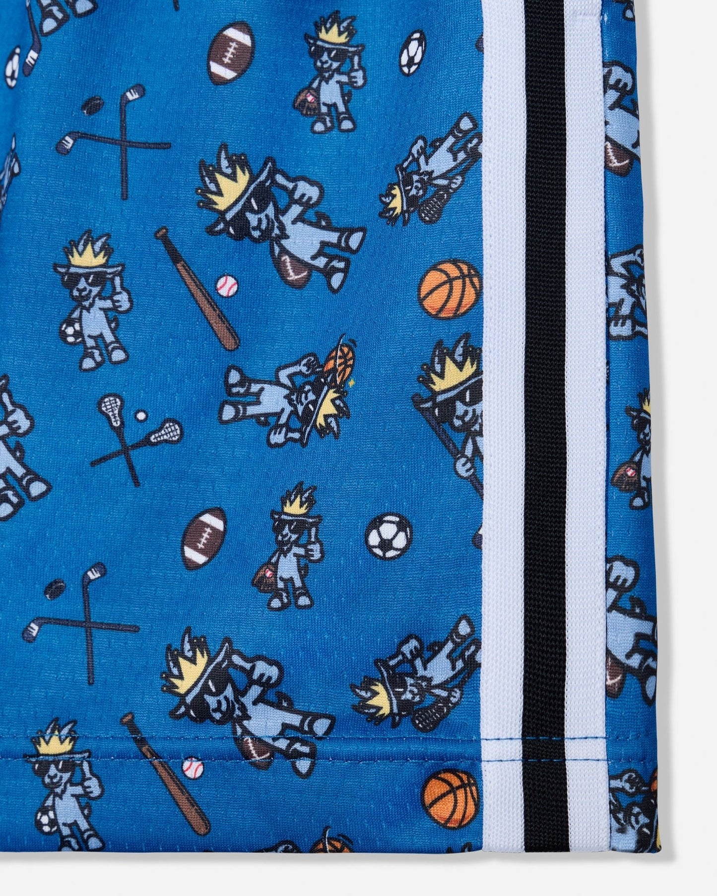 Close-up of a blue fabric product with an allover print of cartoon mascot figures and sports balls, plus a vertical black, white, and blue striped trim on the right side.