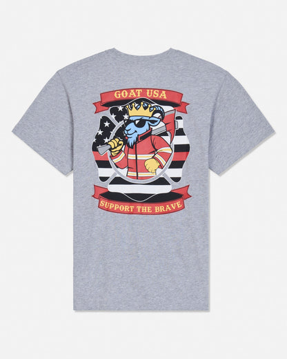 A heather gray short-sleeve t-shirt shown from the back, featuring a large graphic print of a cartoon goat wearing a crown and sunglasses, with red banners reading 'GOAT USA' and 'SUPPORT THE BRAVE'.