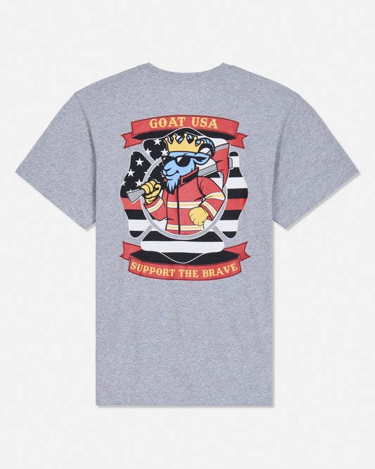 A heather gray short-sleeve t-shirt shown from the back, featuring a large graphic print of a cartoon goat wearing a crown and sunglasses, with red banners reading 'GOAT USA' and 'SUPPORT THE BRAVE'.