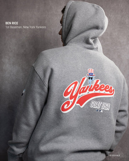 A person shown from the back wearing a heather gray hoodie with a large red, white, and blue New York Yankees graphic on the back. The image includes text identifying the model as Ben Rice, 1st Baseman, New York Yankees.