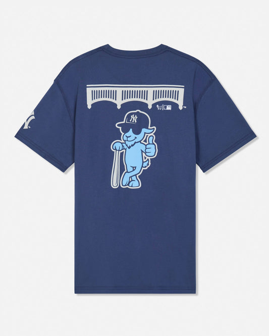 A navy blue short-sleeve t-shirt shown from the back, featuring a large graphic of a light blue cartoon goat wearing a New York Yankees cap and holding a bat, with a white bridge graphic above.